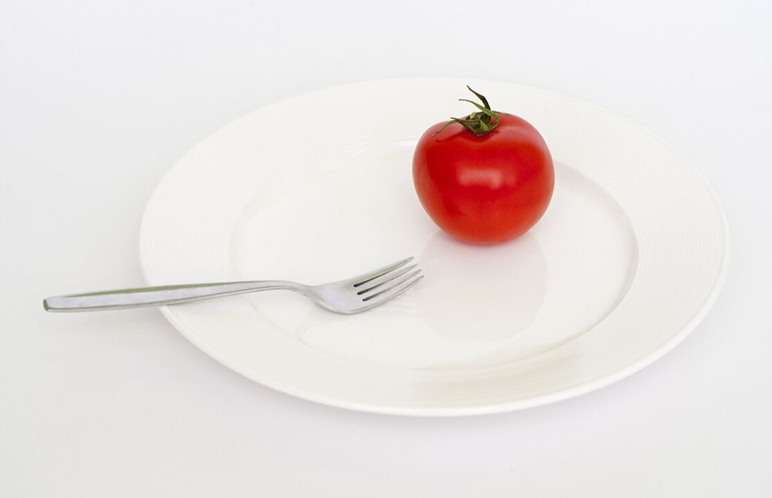 Tomato on a plate with a fork